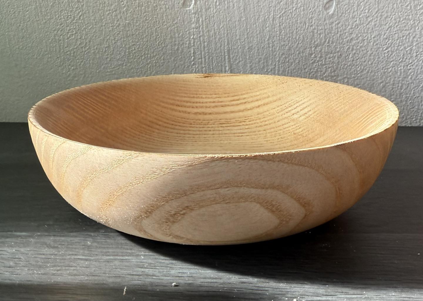 Hand-turned ash wood bowl showing pale grain detail